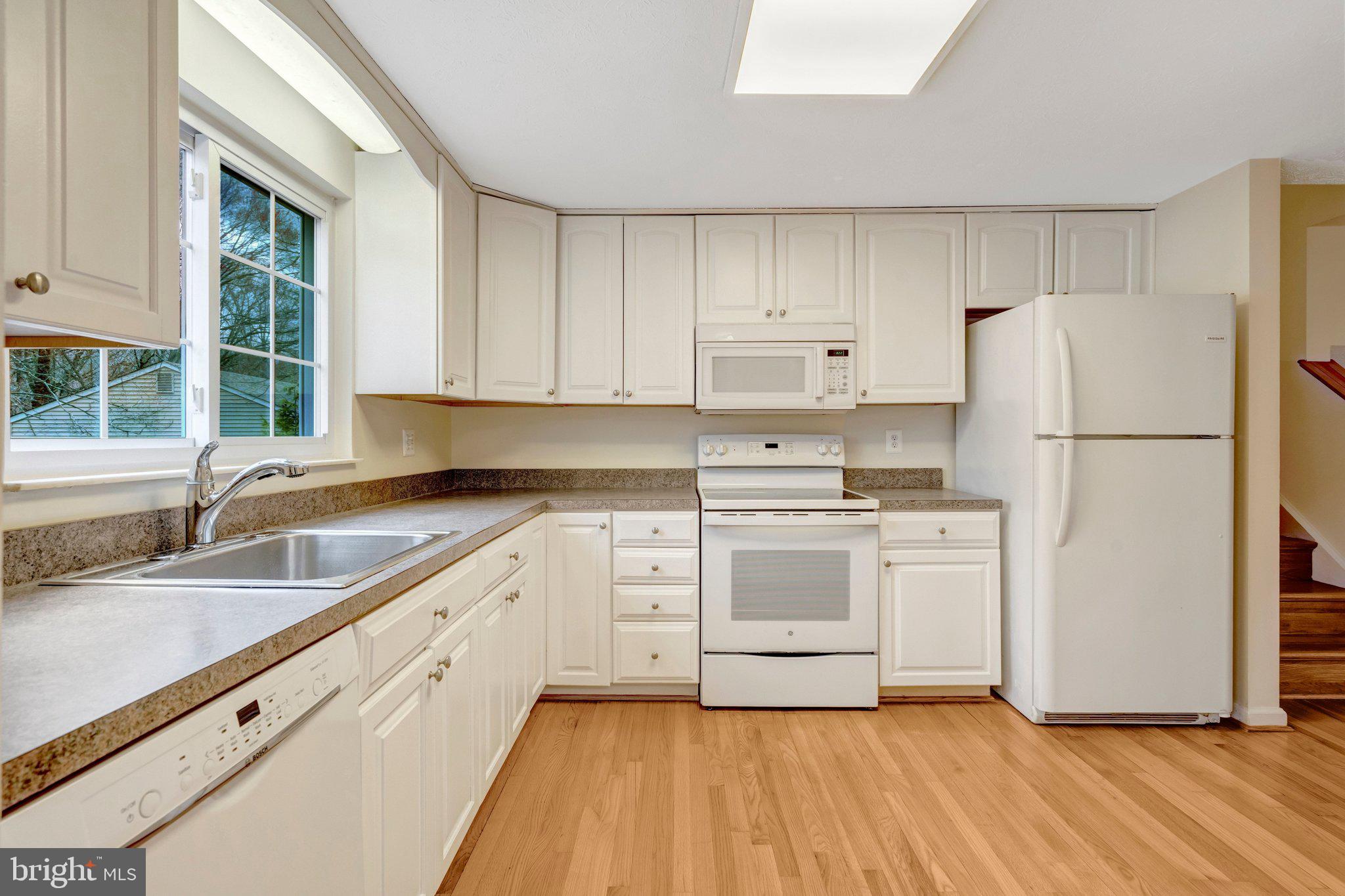 7743 Middle Valley Drive Springfield, VA 22153 - Photo 4 of 17 a kitchen with granite countertop white cabinets and white appliances
