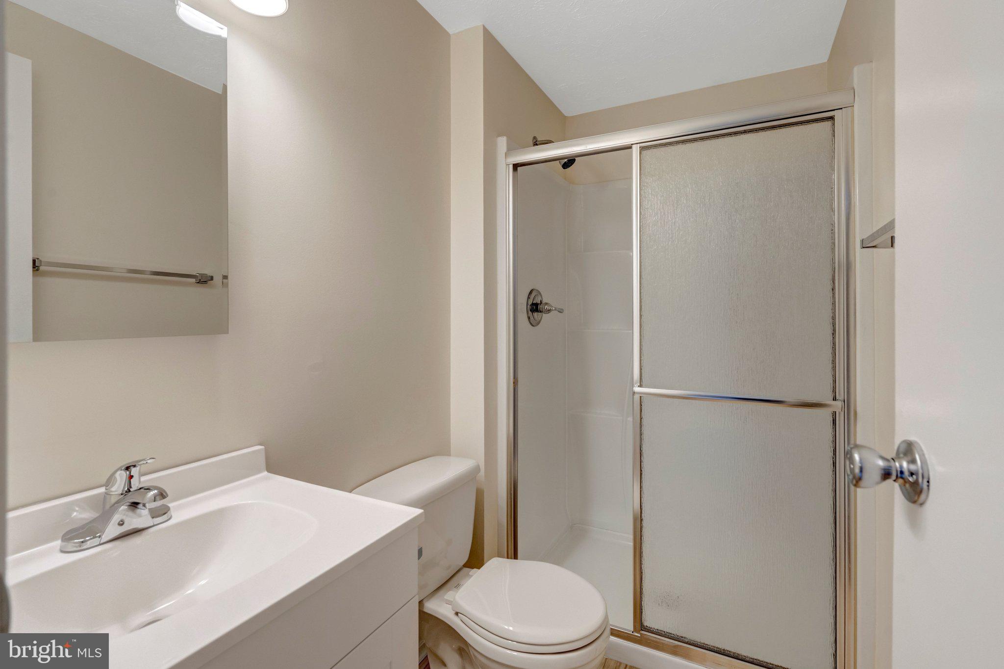 7743 Middle Valley Drive Springfield, VA 22153 - Photo 10 of 17 a white toilet sitting next to a bathroom sink