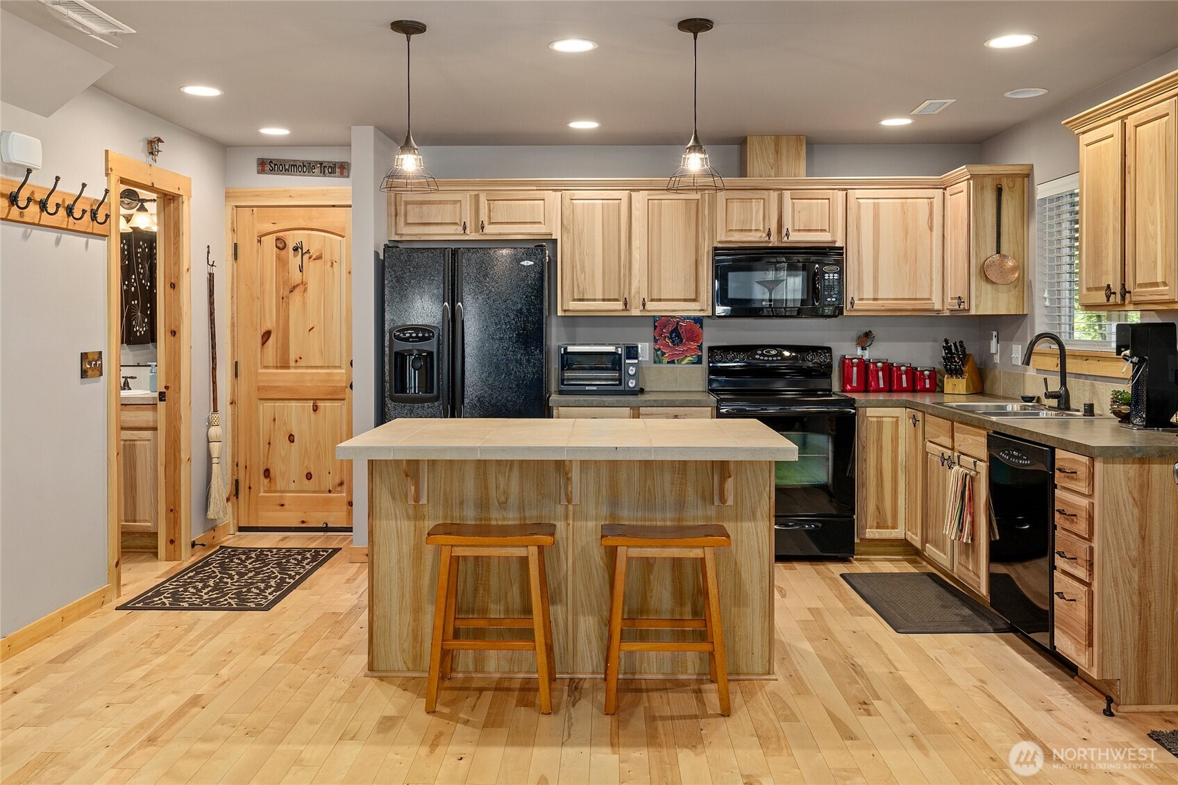 200 Clearwater Loop, Unit 1 Ronald, WA 98940 - Photo 11 of 40 a kitchen with kitchen island granite countertop a stove top oven a sink dishwasher a refrigerator oven and a cabinets with wooden floor