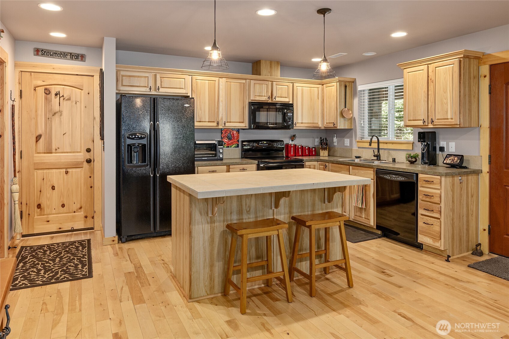 200 Clearwater Loop, Unit 1 Ronald, WA 98940 - Photo 12 of 40 a kitchen with stainless steel appliances granite countertop a refrigerator a stove a sink a dining table and chairs with wooden floor