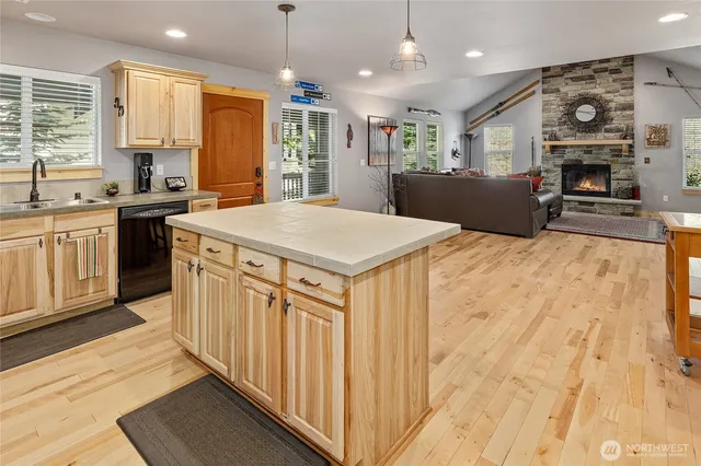 a large kitchen with stainless steel appliances kitchen island granite countertop a sink and cabinets