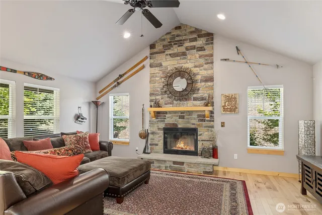 a living room with furniture a flat screen tv and a fireplace