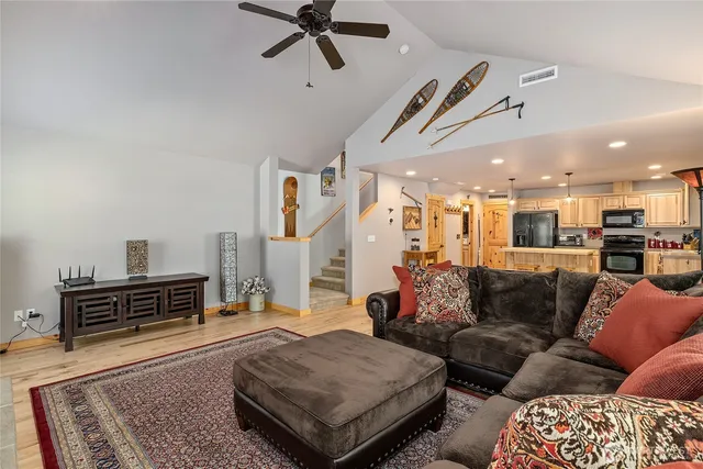 a living room with furniture and wooden floor