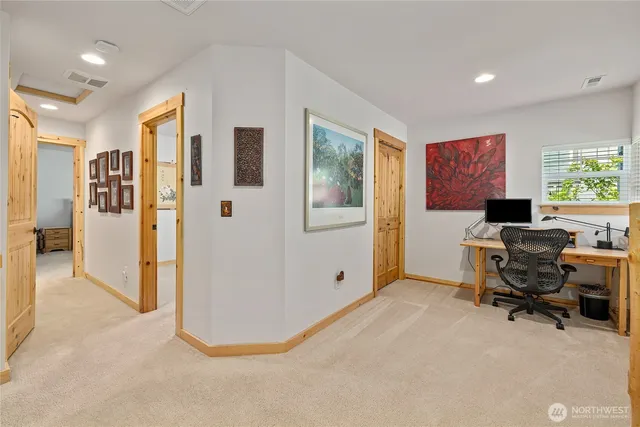 a view of a livingroom with workspace and a window