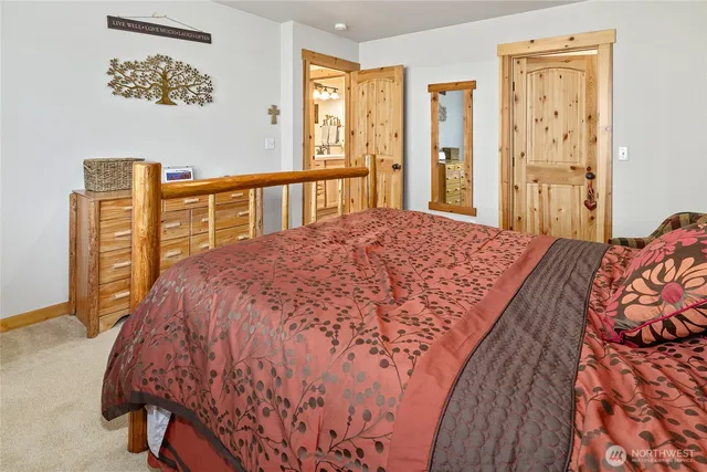 a bed sitting in a bedroom next to a window