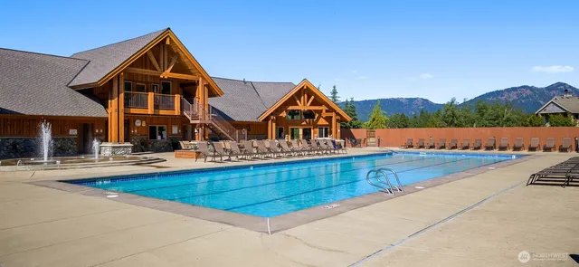 a view of a swimming pool with an outdoor seating