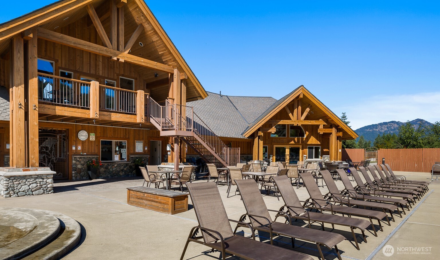 200 Clearwater Loop, Unit 1 Ronald, WA 98940 - Photo 37 of 40 a view of a patio with couches table and chairs with wooden floor and fence