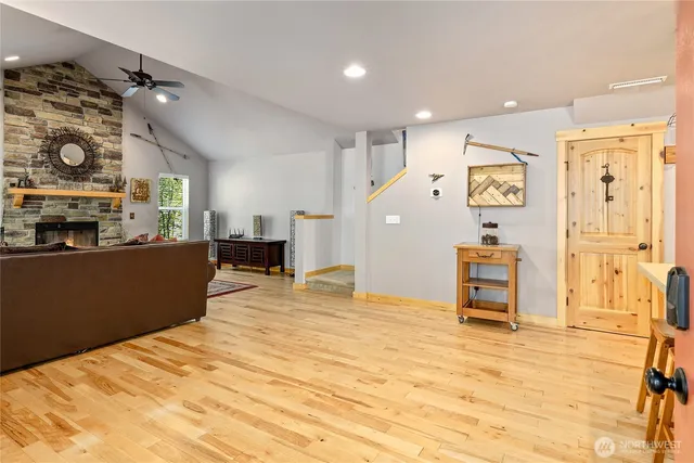 a large kitchen with stainless steel appliances kitchen island granite countertop a refrigerator and a stove top oven