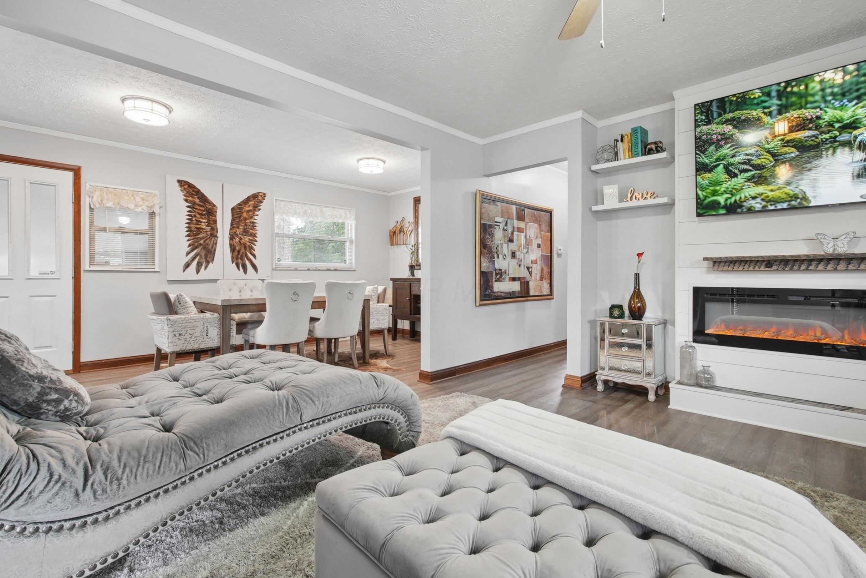 1636 Courtright Road Columbus, OH 43227 - Photo 32 of 35 Beautiful open floor plan featuring luxury vinyl plank flooring throughout the main areas, with a custom built-in electric fireplace with shiplap a mantel, and so much more to see!