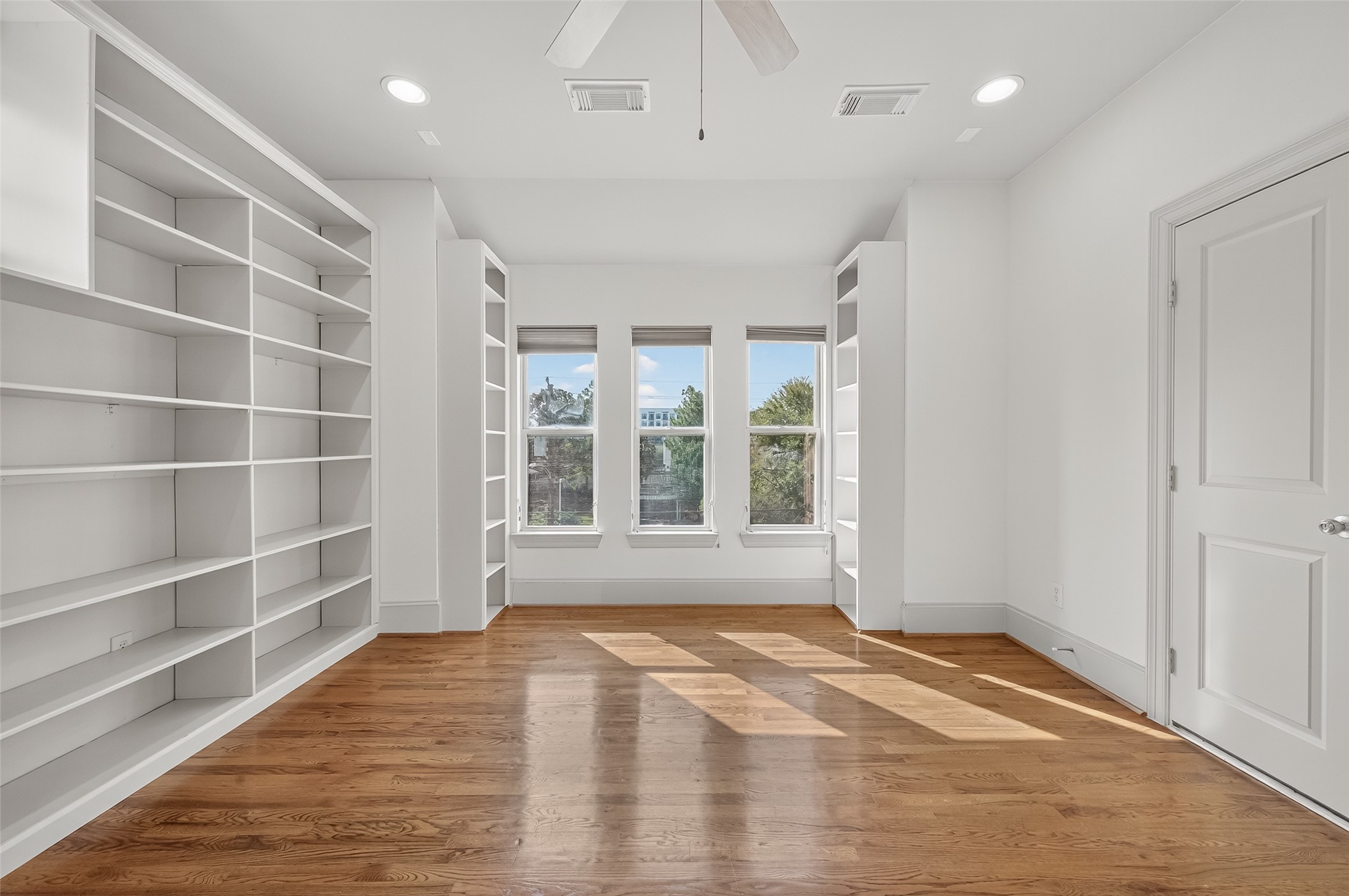 931 West 23rd Street, Unit K Houston, TX 77008 - Photo 28 of 40 3rd floor secondary bedroom is 10'3" x 14'6". This room is currently set up as an office and has carpet, ceiling fan, recessed lights and 5'4" x 3'4" walk-in closet with built-in shelving and hanging racks.