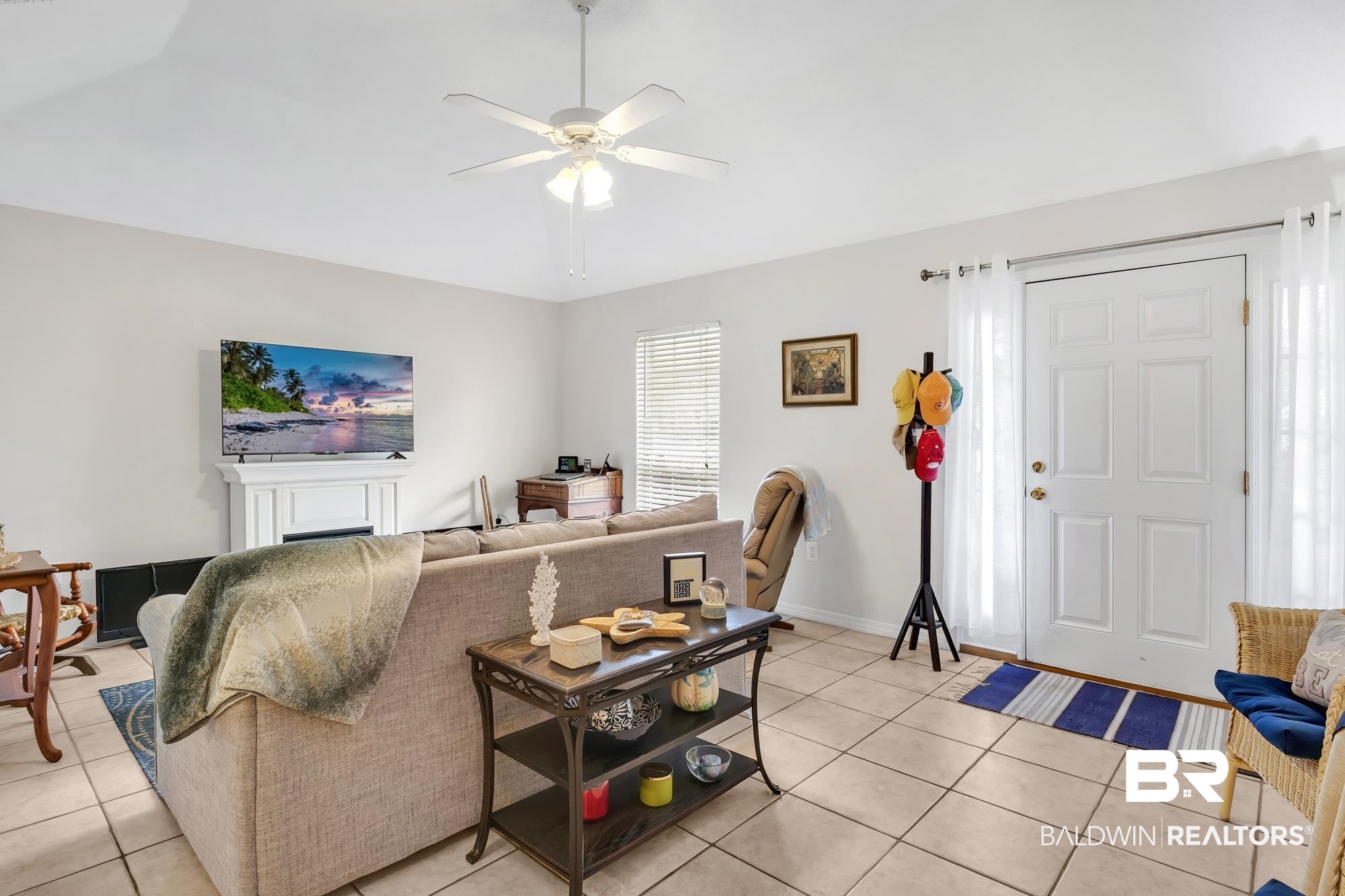 105 Cluster Oaks Court Foley, AL 36535 - Photo 11 of 26 Living area featuring light tile patterned flooring, a ceiling fan, and vaulted ceiling