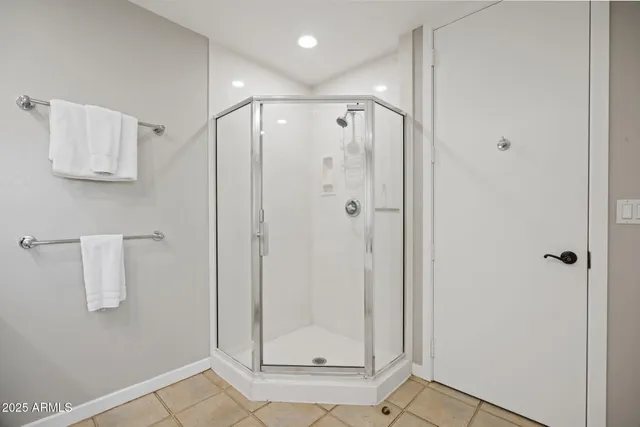 a bathroom with a shower and a mirror