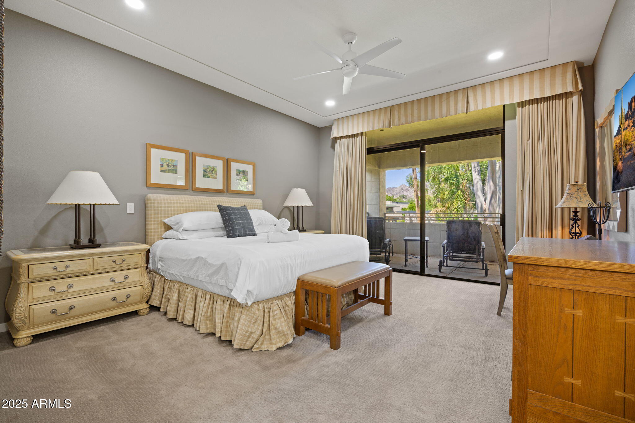 2802 East Camino Acequia Drive, Unit 8 Phoenix, AZ 85016 - Photo 20 of 34 a spacious bedroom with a bed and a dresser next to a window