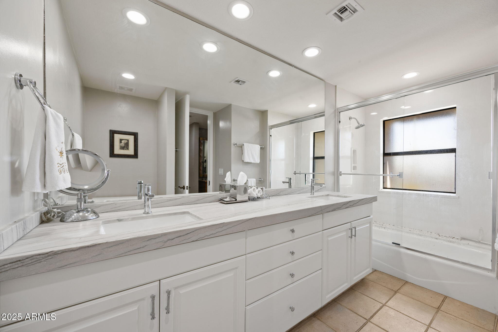 2802 East Camino Acequia Drive, Unit 8 Phoenix, AZ 85016 - Photo 23 of 34 a bathroom with double sink a large mirror and a shower