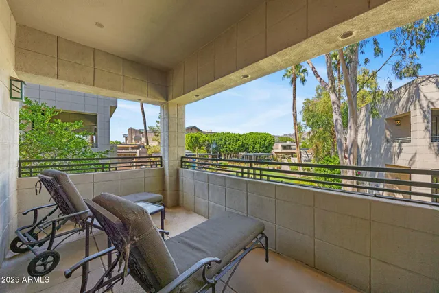 a dining room with furniture and a floor to ceiling window