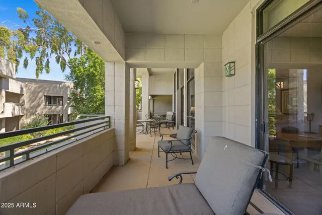 a view of a chairs and table in the balcony