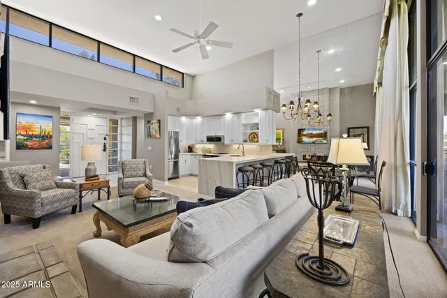 a living room with furniture and kitchen view