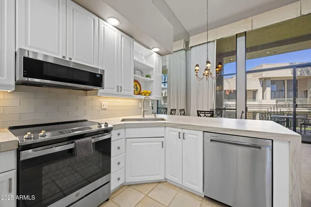 a kitchen with stainless steel appliances granite countertop a stove and a microwave