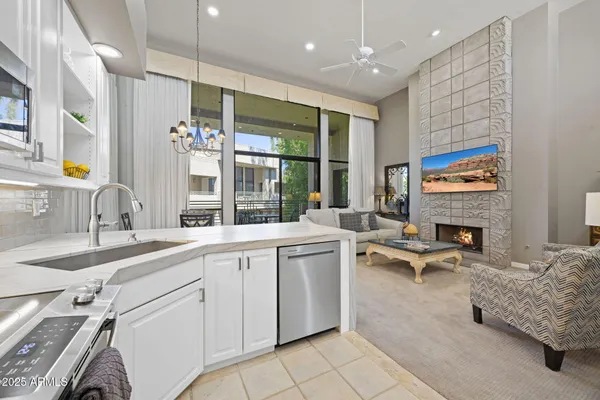 a large white kitchen with a large window