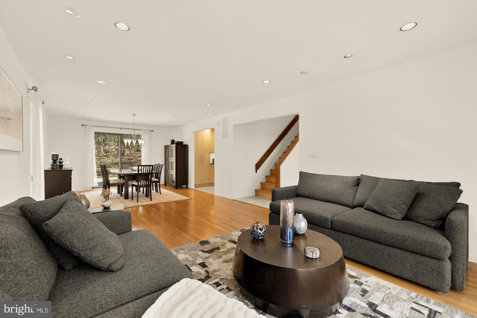 10419 Crossing Creek Road Potomac, MD 20854 - Photo 14 of 74 a living room with furniture and a dining table