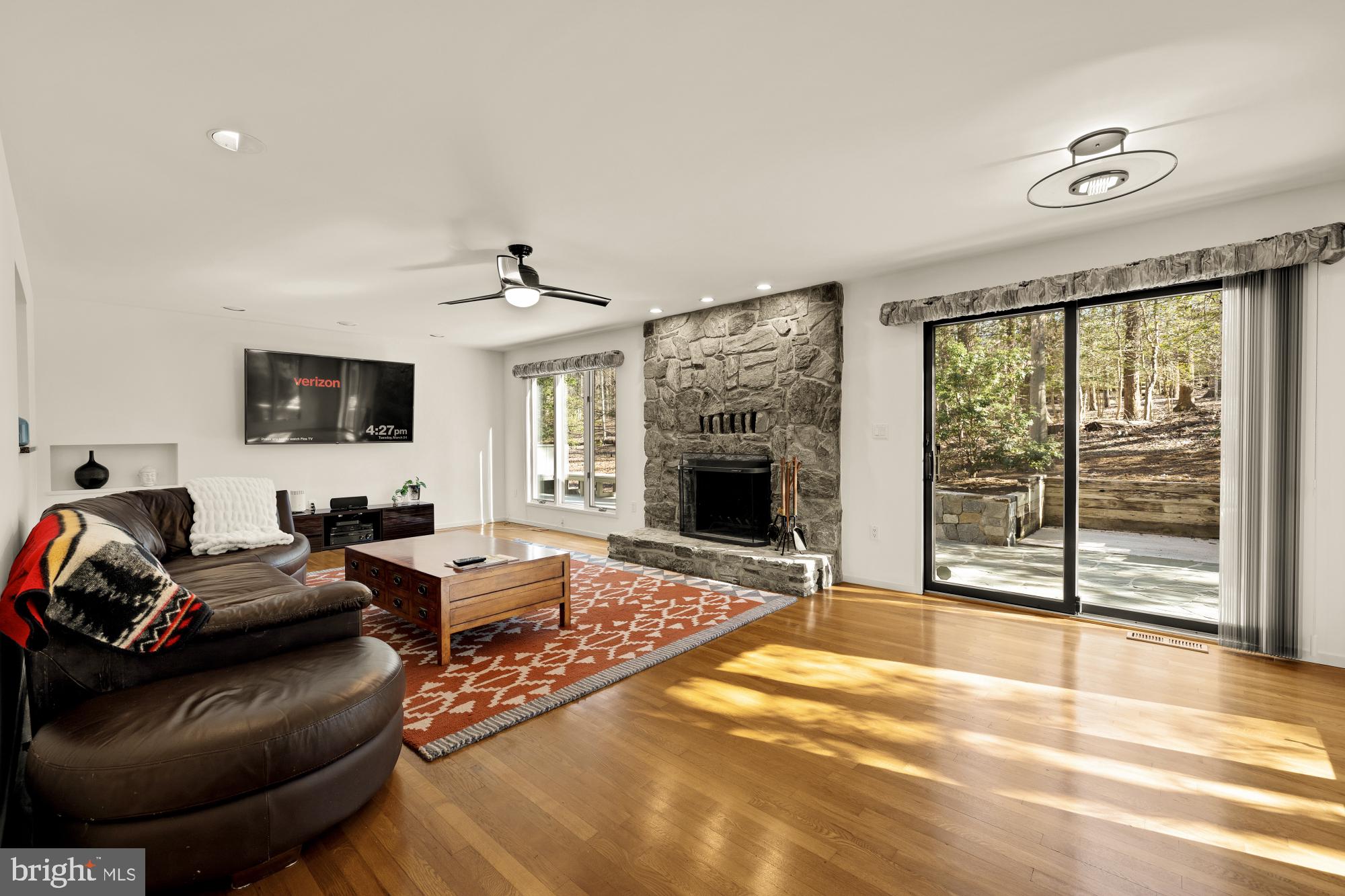 10419 Crossing Creek Road Potomac, MD 20854 - Photo 23 of 74 a living room with furniture a flat screen tv and a fireplace