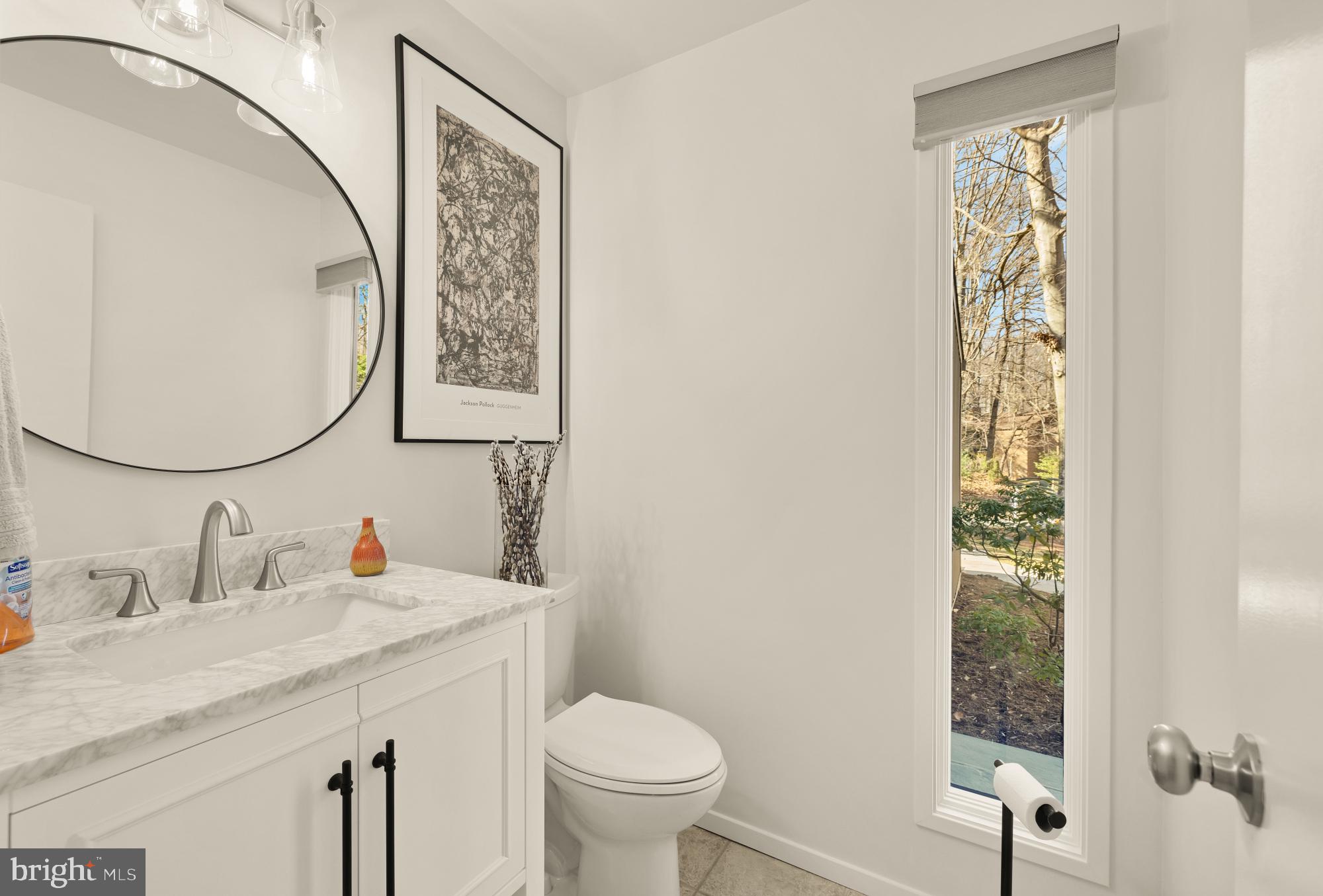 10419 Crossing Creek Road Potomac, MD 20854 - Photo 25 of 74 a bathroom with a granite countertop sink toilet and a mirror