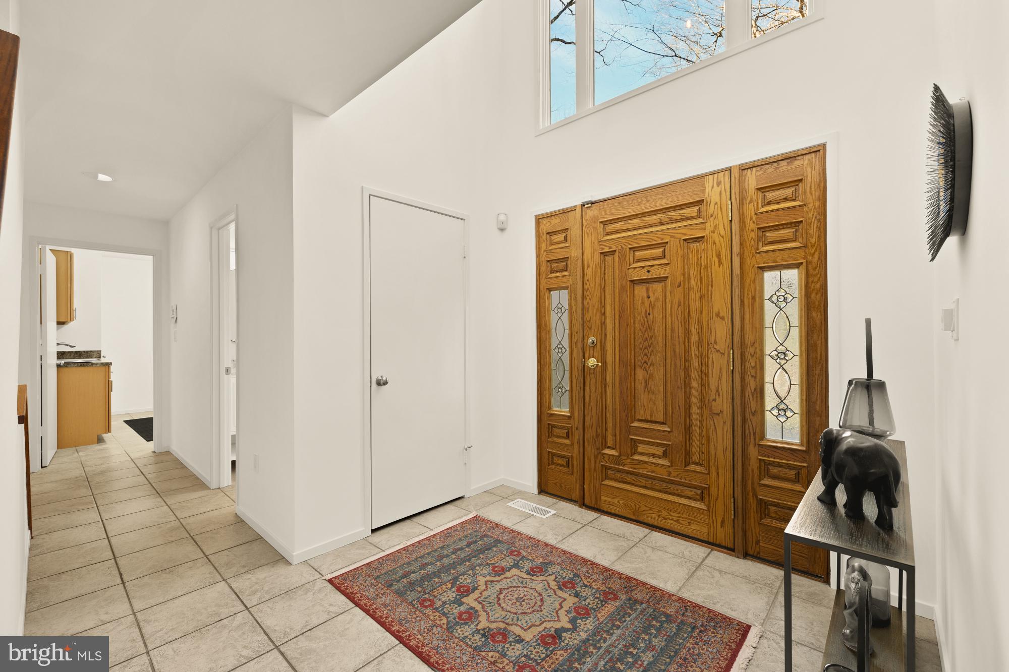 10419 Crossing Creek Road Potomac, MD 20854 - Photo 3 of 74 a view of a hallway to a livingroom with furniture and a window