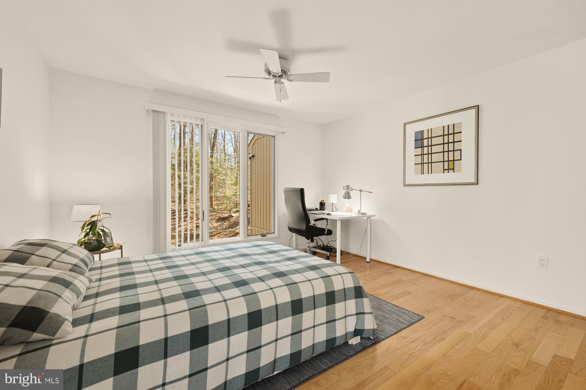 10419 Crossing Creek Road Potomac, MD 20854 - Photo 48 of 74 a bedroom with a bed and wooden floor