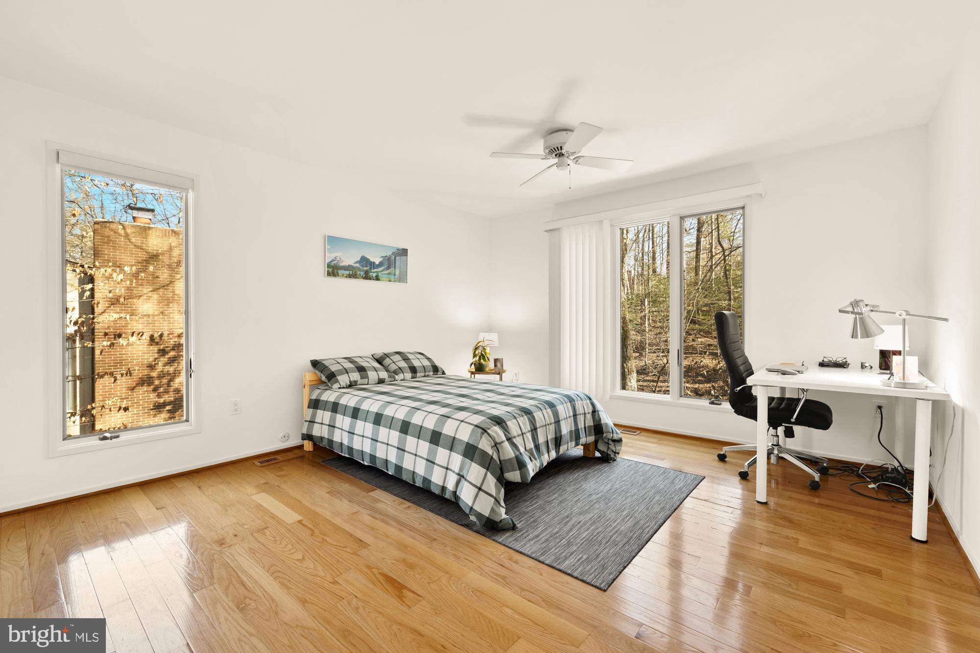 10419 Crossing Creek Road Potomac, MD 20854 - Photo 49 of 74 a spacious bedroom with a bed and a table in it