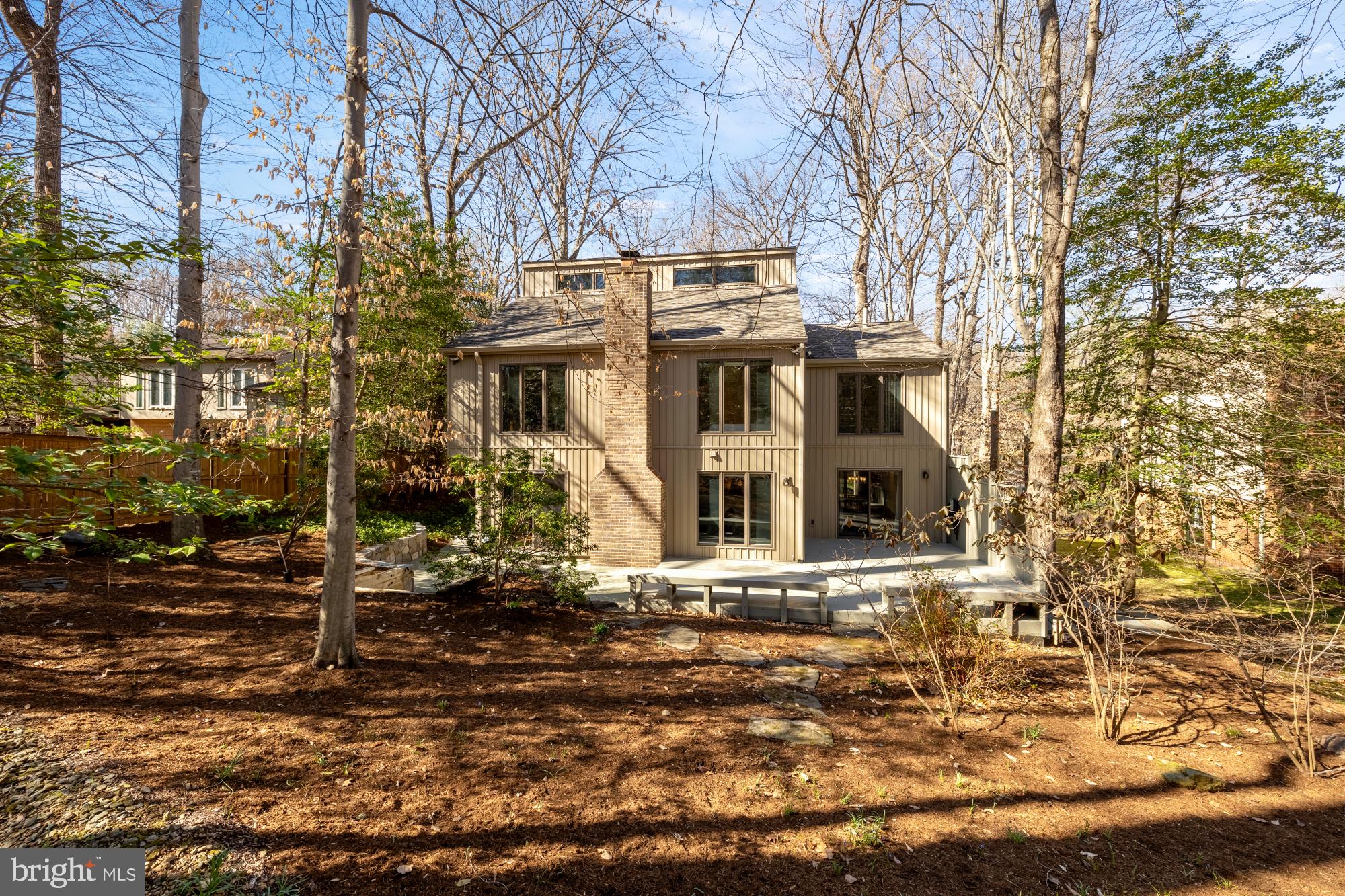10419 Crossing Creek Road Potomac, MD 20854 - Photo 68 of 74 a view of a white house next to a yard with large trees