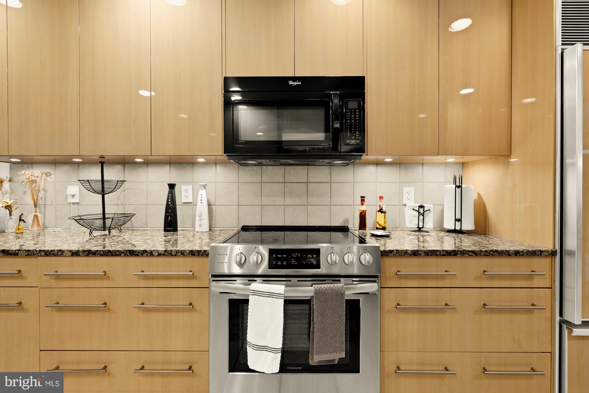 10419 Crossing Creek Road Potomac, MD 20854 - Photo 8 of 74 a kitchen with granite countertop a stove and a sink