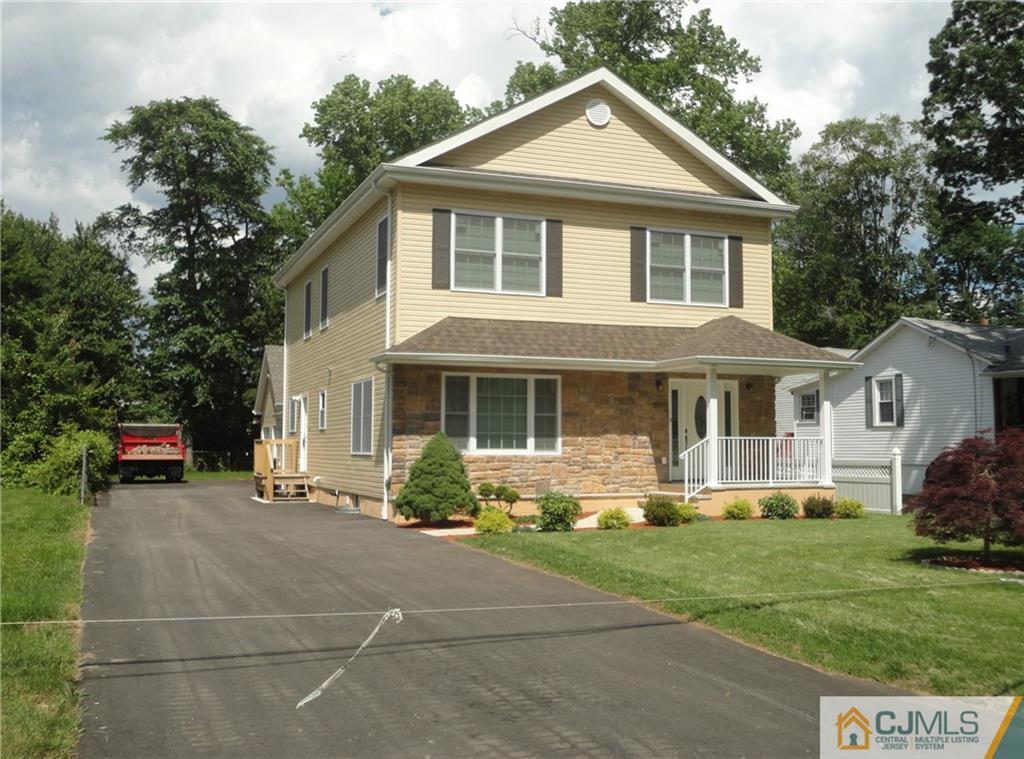 715 Spruce Road North Brunswick, NJ 08902 - Photo 1 of 23 a front view of a house with a yard and porch