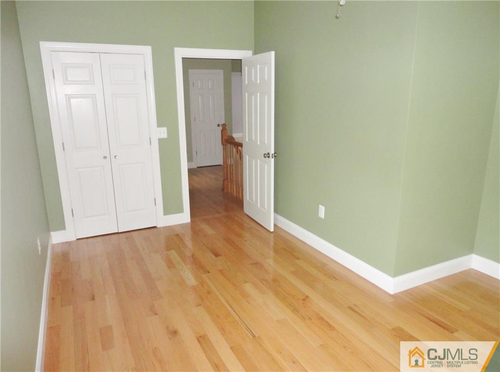 715 Spruce Road North Brunswick, NJ 08902 - Photo 12 of 23 a view of a hallway with wooden floor