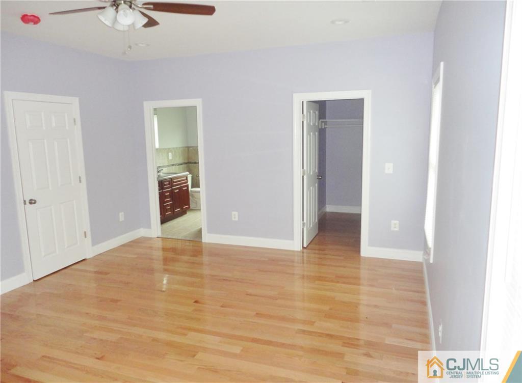 715 Spruce Road North Brunswick, NJ 08902 - Photo 13 of 23 a view of an empty room with chandelier fan