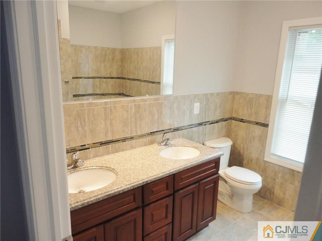 715 Spruce Road North Brunswick, NJ 08902 - Photo 14 of 23 a bathroom with a granite countertop sink toilet and shower