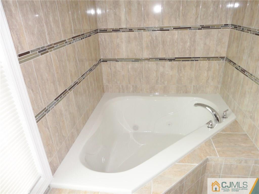 715 Spruce Road North Brunswick, NJ 08902 - Photo 15 of 23 a bathroom with a white bath tub and a shower