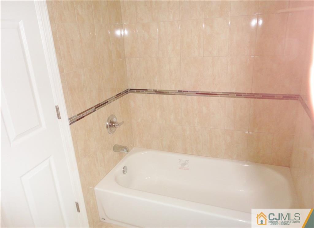 715 Spruce Road North Brunswick, NJ 08902 - Photo 10 of 23 a bathroom with a bathtub and a shower