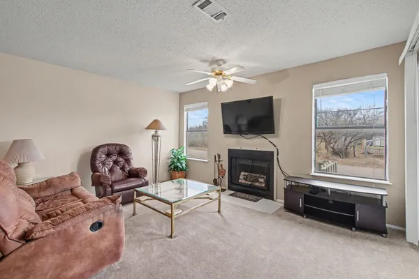 a living room with furniture a fireplace and a flat screen tv