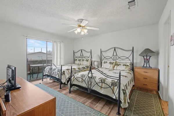 a bedroom with two beds and a large window