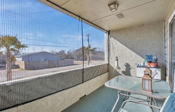 a view of a balcony dining table and chairs