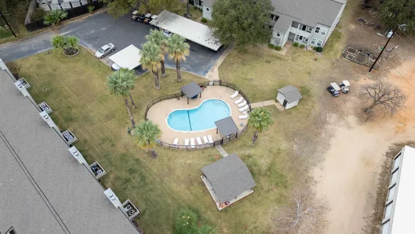 an aerial view of a house with a yard