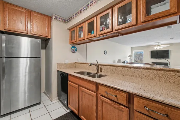 a kitchen with stainless steel appliances granite countertop a refrigerator and a sink