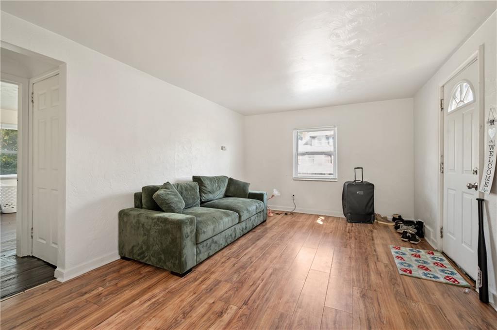1627-1629 Laketon Road Pittsburgh, PA 15221 - Photo 11 of 26 a living room with furniture and a wooden floor