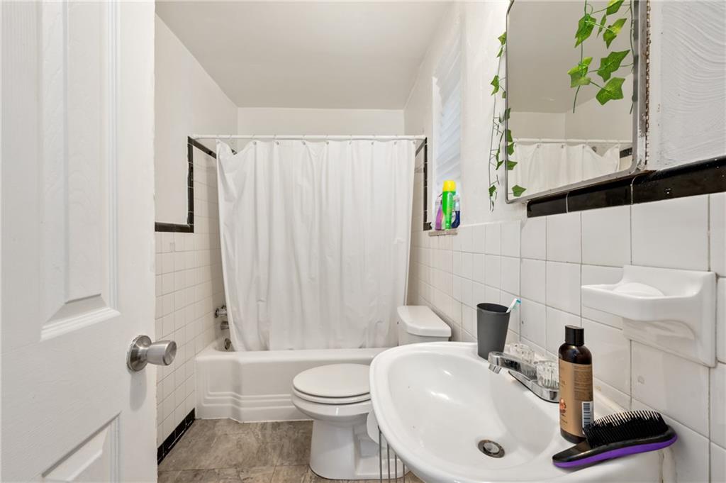 1627-1629 Laketon Road Pittsburgh, PA 15221 - Photo 12 of 26 a bathroom with a sink a toilet and shower