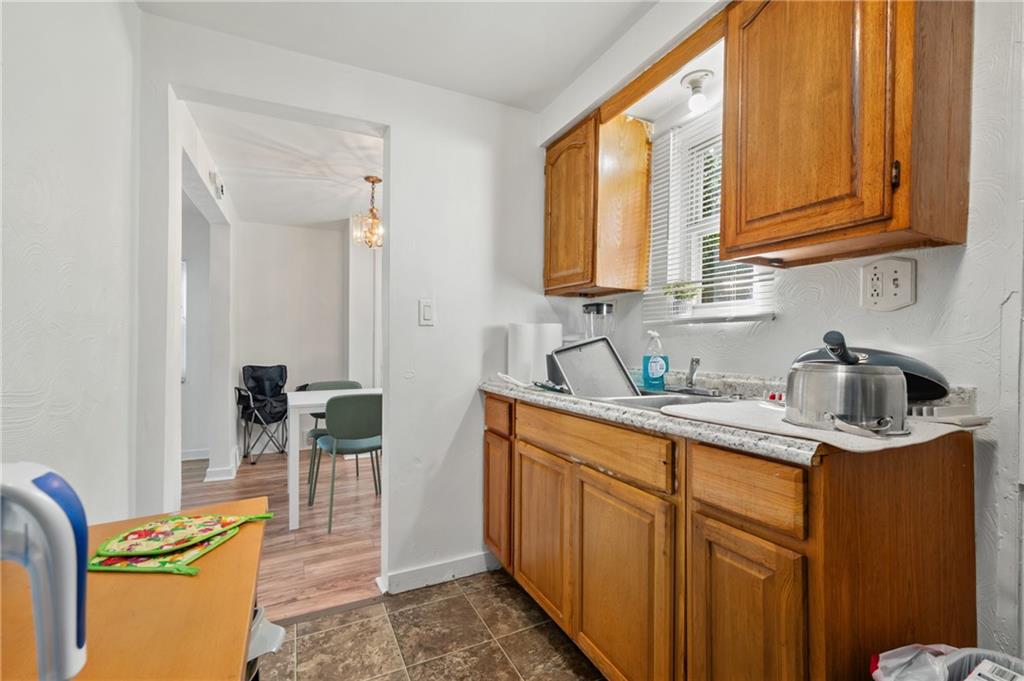 1627-1629 Laketon Road Pittsburgh, PA 15221 - Photo 15 of 26 a kitchen with stainless steel appliances granite countertop a sink stove and cabinets