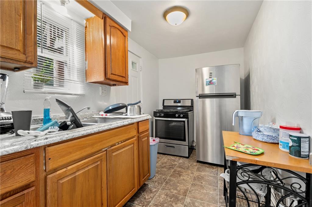 1627-1629 Laketon Road Pittsburgh, PA 15221 - Photo 16 of 26 a kitchen with a sink appliances and cabinets