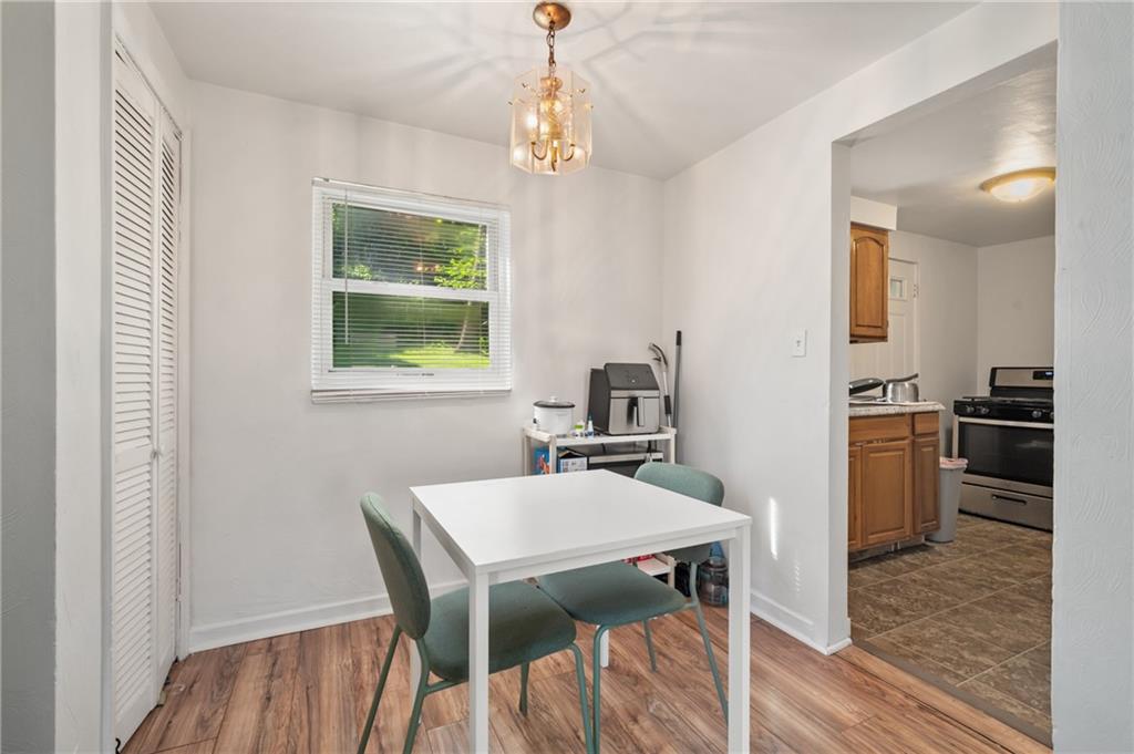 1627-1629 Laketon Road Pittsburgh, PA 15221 - Photo 18 of 26 a kitchen with a table chairs refrigerator and microwave