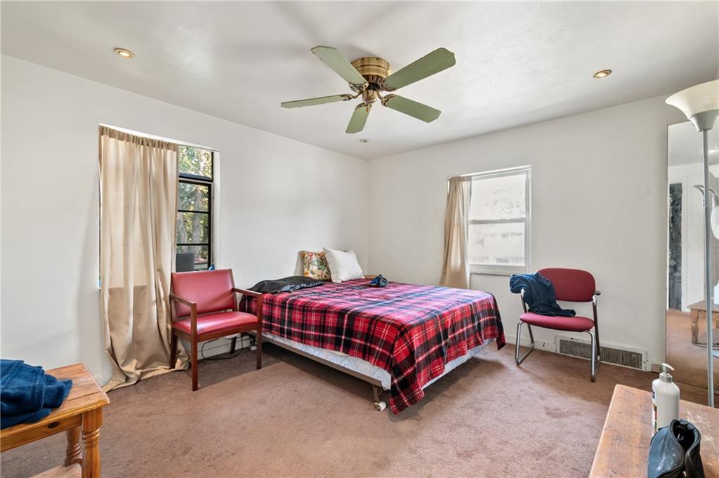 1627-1629 Laketon Road Pittsburgh, PA 15221 - Photo 20 of 26 a bedroom with a bed chair and a window
