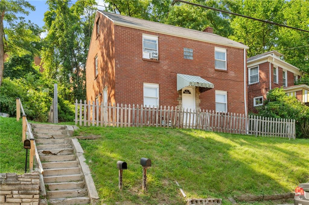 1627-1629 Laketon Road Pittsburgh, PA 15221 - Photo 2 of 26 a front view of a house with yard