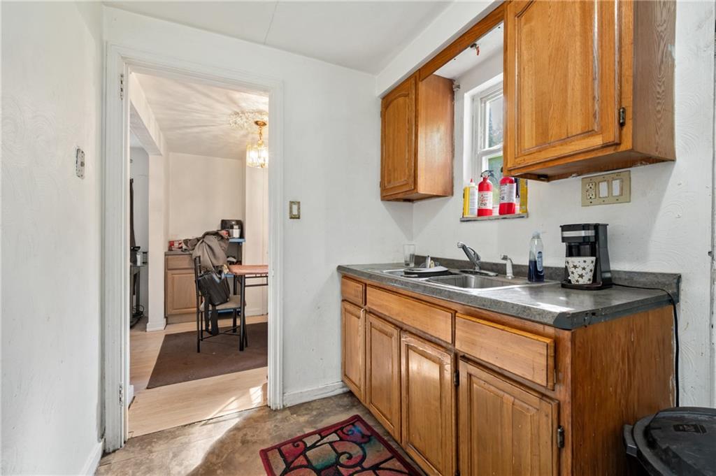 1627-1629 Laketon Road Pittsburgh, PA 15221 - Photo 21 of 26 a kitchen with stainless steel appliances granite countertop a stove a sink and a microwave